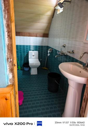 a bathroom with a toilet and a sink at Golays homestay in Kalimpong