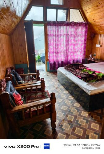 a bedroom with two beds and a window at Golays homestay in Kalimpong