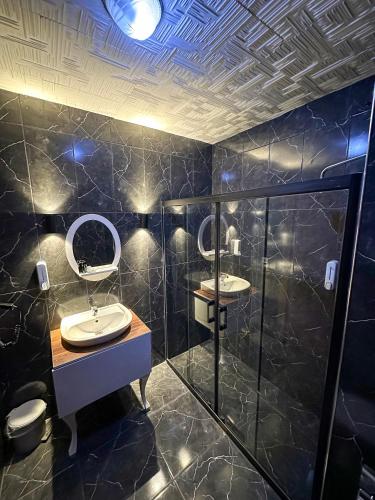 a bathroom with two sinks and a shower at Safir Hotels Silivri in Silivri