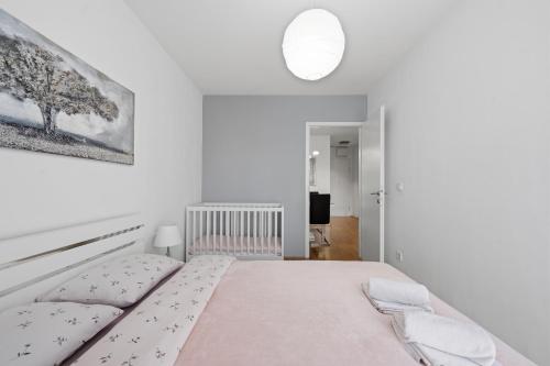 a white bedroom with a large bed in a room at Apartman Tonka in Šibenik