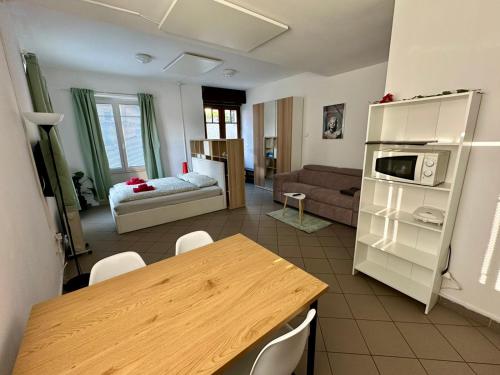 a kitchen and living room with a table and a couch at Soca treasure with free parking in Bovec