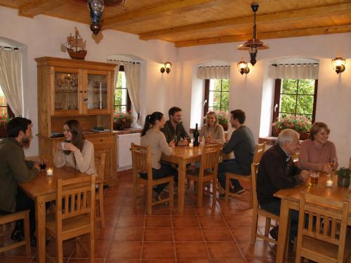 a group of people sitting at a table in a restaurant at Penzion Vital in Liberec