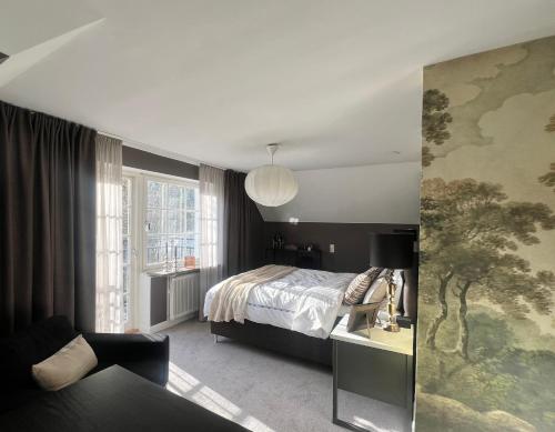 a bedroom with a bed and a living room at Spacious, comfortable villa close to lake in Sigtuna