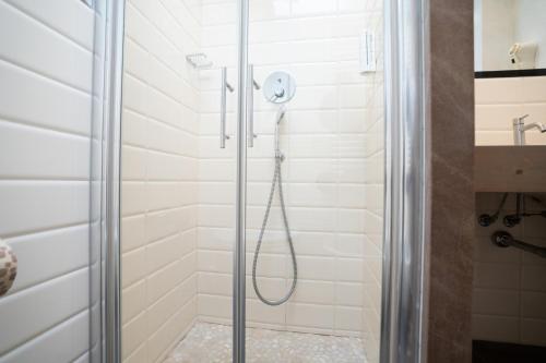 a shower with a glass door in a bathroom at Hotel Estense in Bellaria-Igea Marina