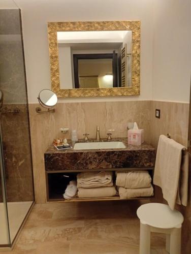 a bathroom with a sink and a mirror at Villa Alliata Relais & Spa in Palermo