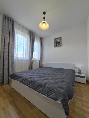 a bedroom with a bed in a white room at Blue Summer in Obzor