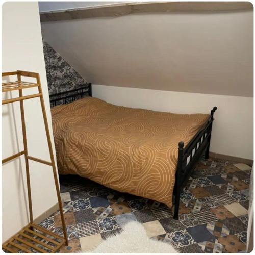 a bedroom with a bed and a ladder at Maison avec jacuzzi in Vierzon