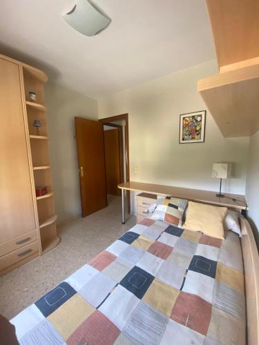 a bedroom with a bed and a desk at Cal Pelat Guimerà in Guimerá