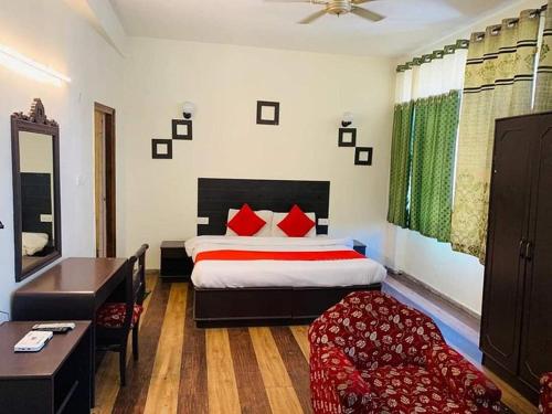 a hotel room with a bed and a desk and a bed sidx sidx at Kalinga Intercontinental By Maa Vaishno Hotels India Pvt Ltd in Manāli