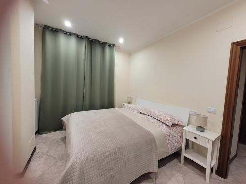 a bedroom with a bed and a green curtain at Bella Todi Apartment 2 in Todi