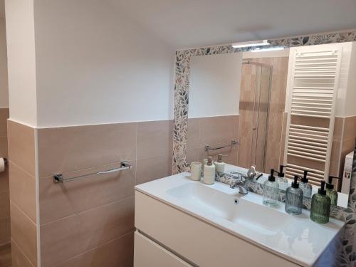 a bathroom with a sink and a mirror at Bella Todi Apartment 2 in Todi