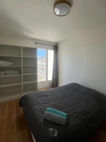 a bedroom with a bed and a window at BayView in Saint-Brieuc