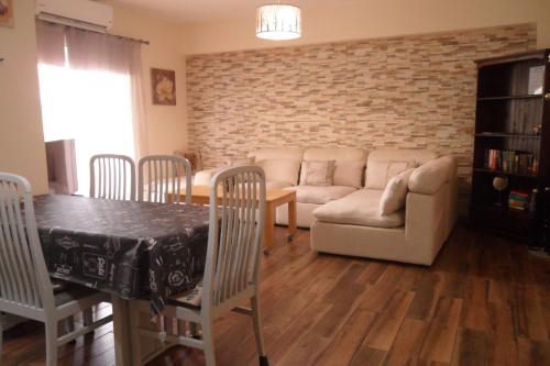 a living room with a couch and a table at SUNSHINE APTS, TWO BEDROOM , FREE INTERNET, No 3 in Ayia Napa