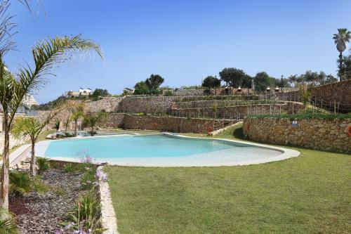 a swimming pool in the middle of a yard at Hal Wardija - Gozo Hideaways in Qala