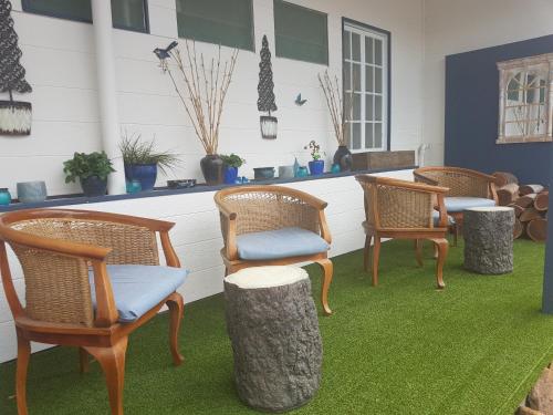 a row of chairs and tables in a grassy area at Monto Colonial Motor Inn in Monto