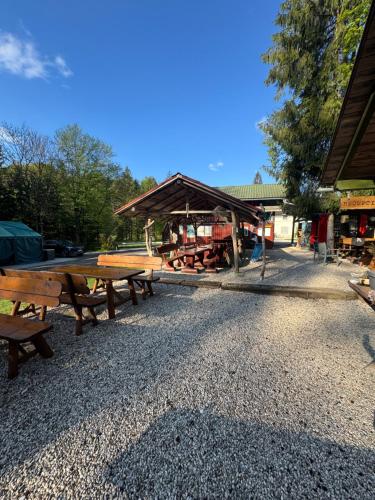 a group of picnic tables in front of a building at Tinaraft camp in Radovljica