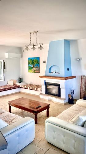 a living room with a couch and a coffee table at Villas Nies in Soúrpi