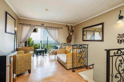 a living room with a couch and a mirror at FlowithLin Guesthouse in Durban
