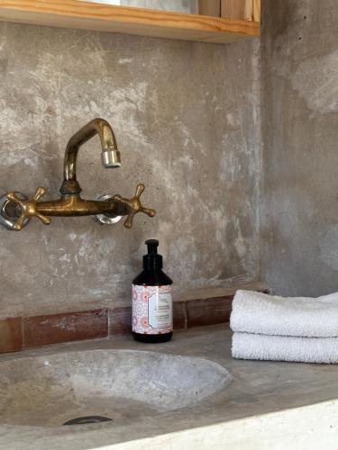 a bottle of soap sitting on a bathroom sink at Villa Quince in Ouirgane