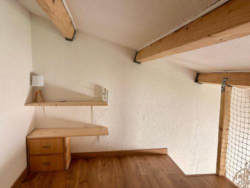 a room with a wooden shelf and a table at Anisades, Maison cosy avec jardin 5 min plage in Le Barcarès