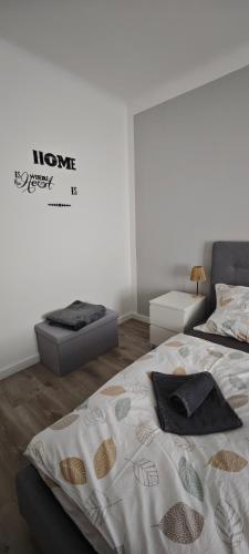 a bedroom with two beds and a sign on the wall at Ferienwohnung Alexander in Niederaigen