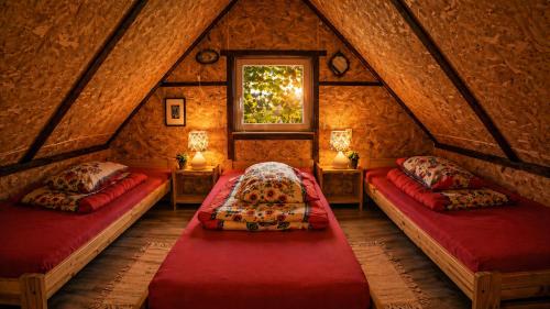 a room with two beds in a attic at Agroturystyka Husinka pl in Husinka