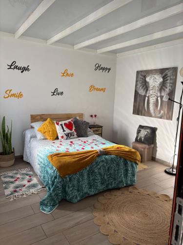 a bedroom with a bed and signs on the wall at Atico Dolce Natura in Arrecife