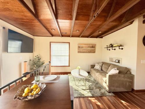 a living room with a couch and a table at Sunlit Loft, Near GSP and Private Entry in Greer