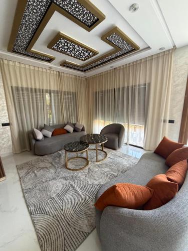 a living room with a couch and a table at Villa Golden Sun in El Jemʼa Ghemat