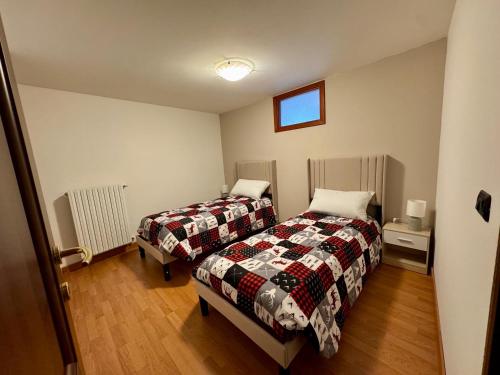 a bedroom with two beds and a window at Maison Champriond in Rif