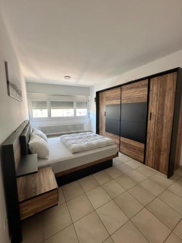 a bedroom with a large bed and a window at B&B bellinzona gino in Bellinzona