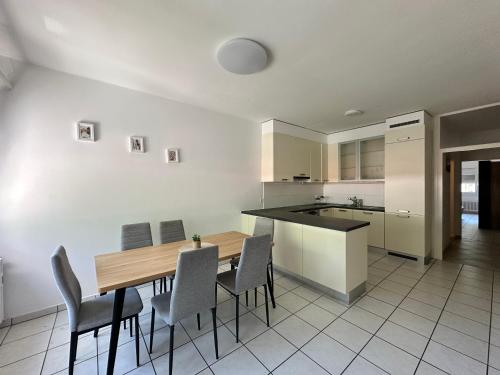 a kitchen with a wooden table and chairs at B&B bellinzona gino in Bellinzona