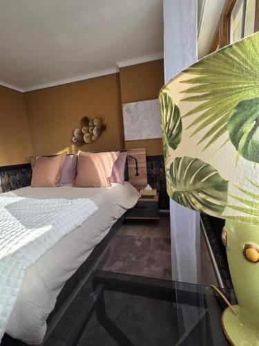a bedroom with a large bed and a window at Chambres d'hotes la forêt in Longwy