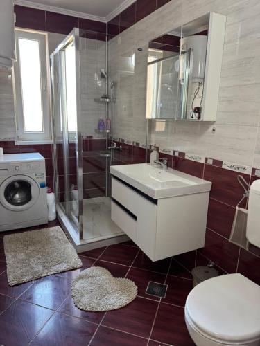 a bathroom with a sink and a toilet and a shower at BLUE MOON in Sarajevo