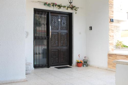 a black door on the side of a house at Salt Lake Town House in Larnaca