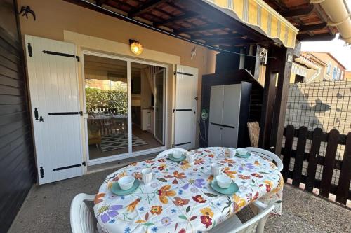 un tavolo e delle sedie su un portico con un tavolo e delle sedie di The beachside coquette a Frontignan