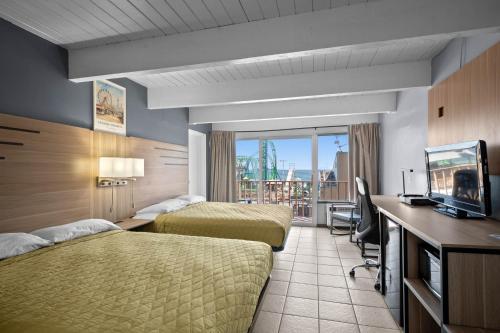 a hotel room with two beds and a television at Aztec Ocean Resort in Seaside Heights