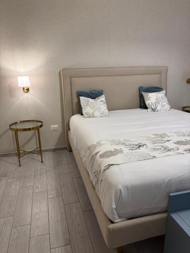 a bedroom with a large bed and a table at Respiro Di Mare in Torre del Greco