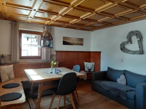 a living room with a couch and a table at Alphüsli Garfrescha in Sankt Gallenkirch