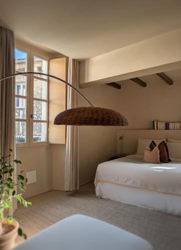 a bedroom with a bed and a large chandelier at Provencal Escape - Suite in Saint Paul de Vence