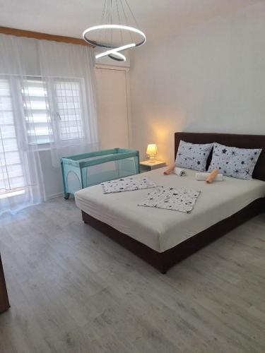 a bedroom with a large bed and a blue table at Apartment Relax in Stolac