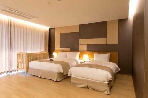 a hotel room with two beds in a room at Incheon Stay Hotel in Incheon