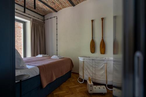 a room with a bed and wooden utensils on the wall at apartamenty64200 in Wolsztyn