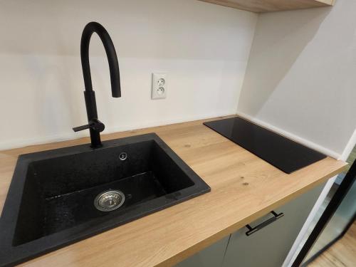 a kitchen with a black sink and a counter at Charming cozy nest - old town in Annecy