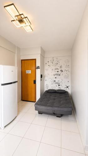 a bedroom with a bed with graffiti on the wall at Studio Moderno e Aconchegante , Centro Unai in Unaí