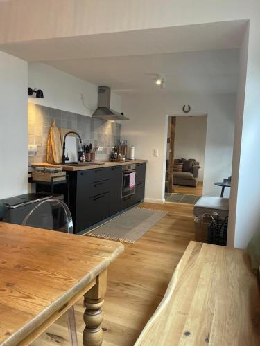 a kitchen with a wooden table in a room at EifelQuartier L9 in Schleiden