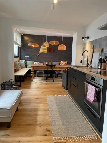a kitchen and living room with a dining room at EifelQuartier L9 in Schleiden
