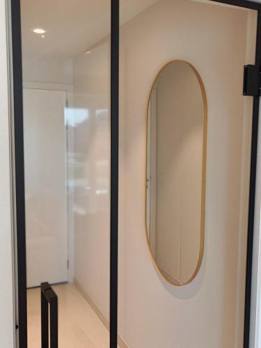a mirror on a door with a hallway at Studio met zeezicht op Heldenplein in Knokke-Heist