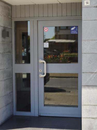 a door to a building with a sign on it at Studio met zeezicht op Heldenplein in Knokke-Heist