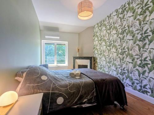 a bedroom with a bed with a blanket on it at Two-bedroom apartment with air conditioning in Vichy